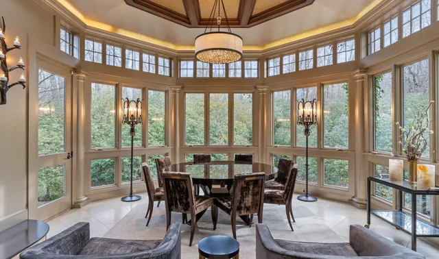 Window-lined dining room with a round table and wood ceiling — Deep River, CT residence