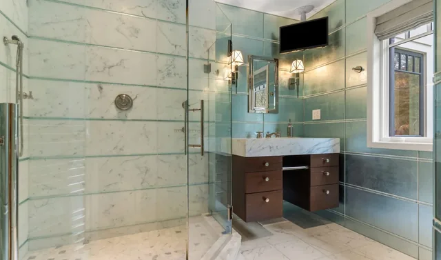 Bathroom with a glass shower and green wall tile — Deep River, CT residence
