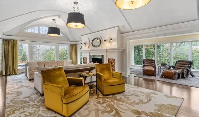 Living room with mustard armchairs and a coffered ceiling — Deep River, CT residence