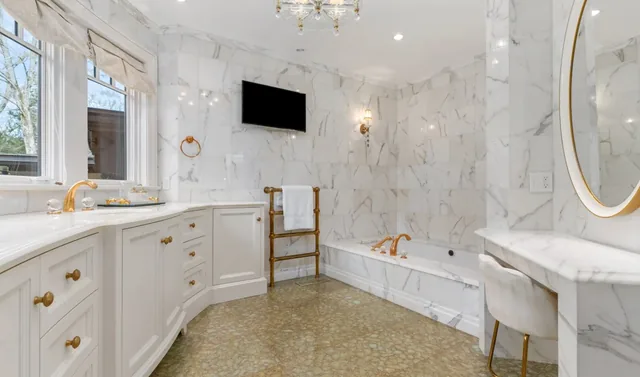 Marble bathroom with a curved vanity and dressing table — Deep River, CT residence
