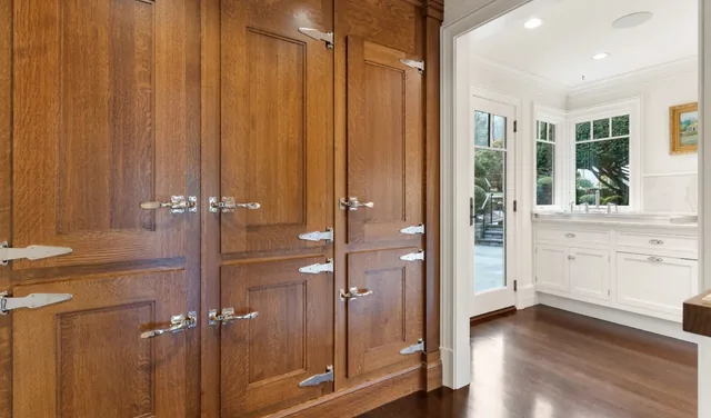 Wood cabinetry beside a bright utility room — Deep River, CT residence