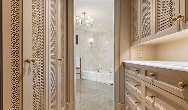Dressing room cabinetry leading to a marble bathroom — Deep River, CT residence