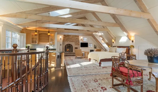 Bedroom beneath exposed timber beams — Deep River, CT residence