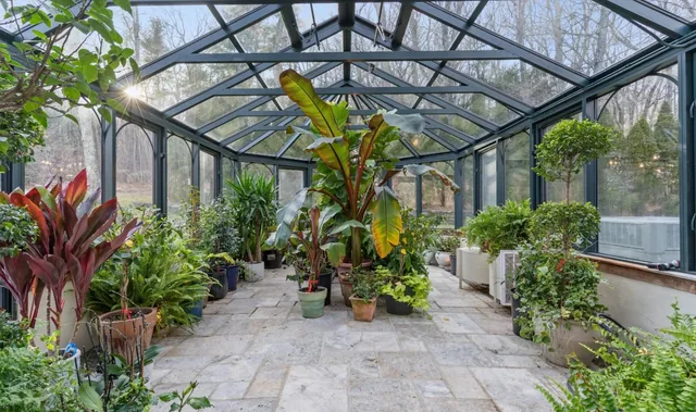 Greenhouse interior with a stone path and planting beds — Deep River, CT residence