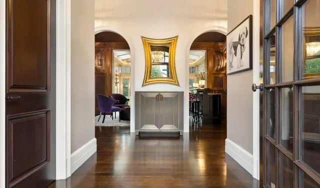 Hallway with dark wood floors and arched openings — Deep River, CT residence