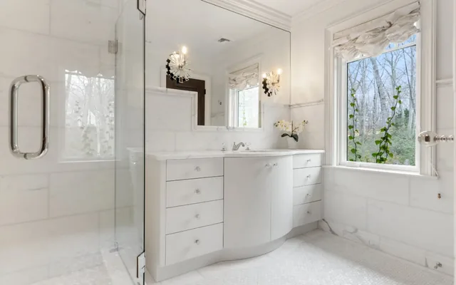 Bathroom with a curved vanity and glass shower — Deep River, CT residence